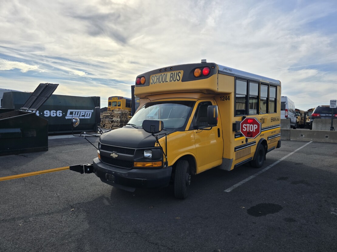 yellow type a school bus with lights on