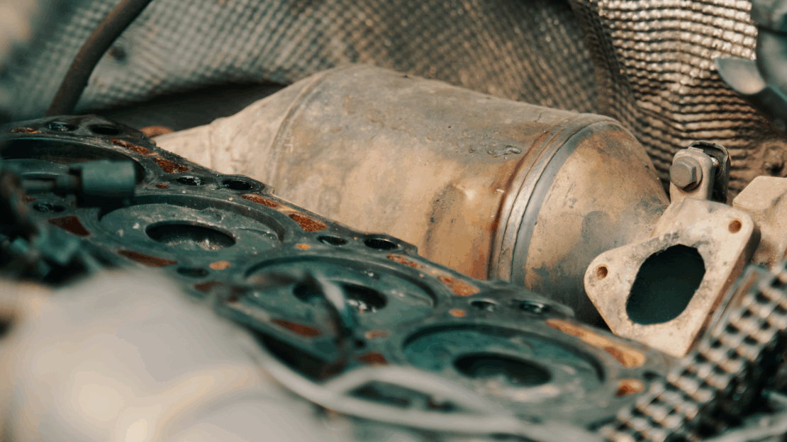 close up image of a diesel particulate filter laid in among the engine parts of a bus